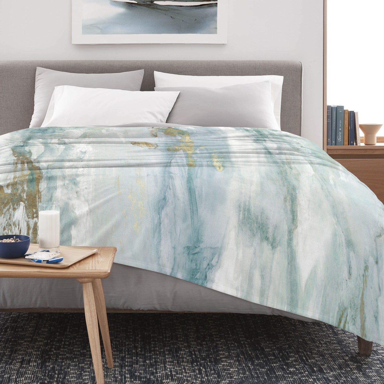 Green abstract flannel blanket with watercolor design on a bed, perfect for sofa or bed made in USA