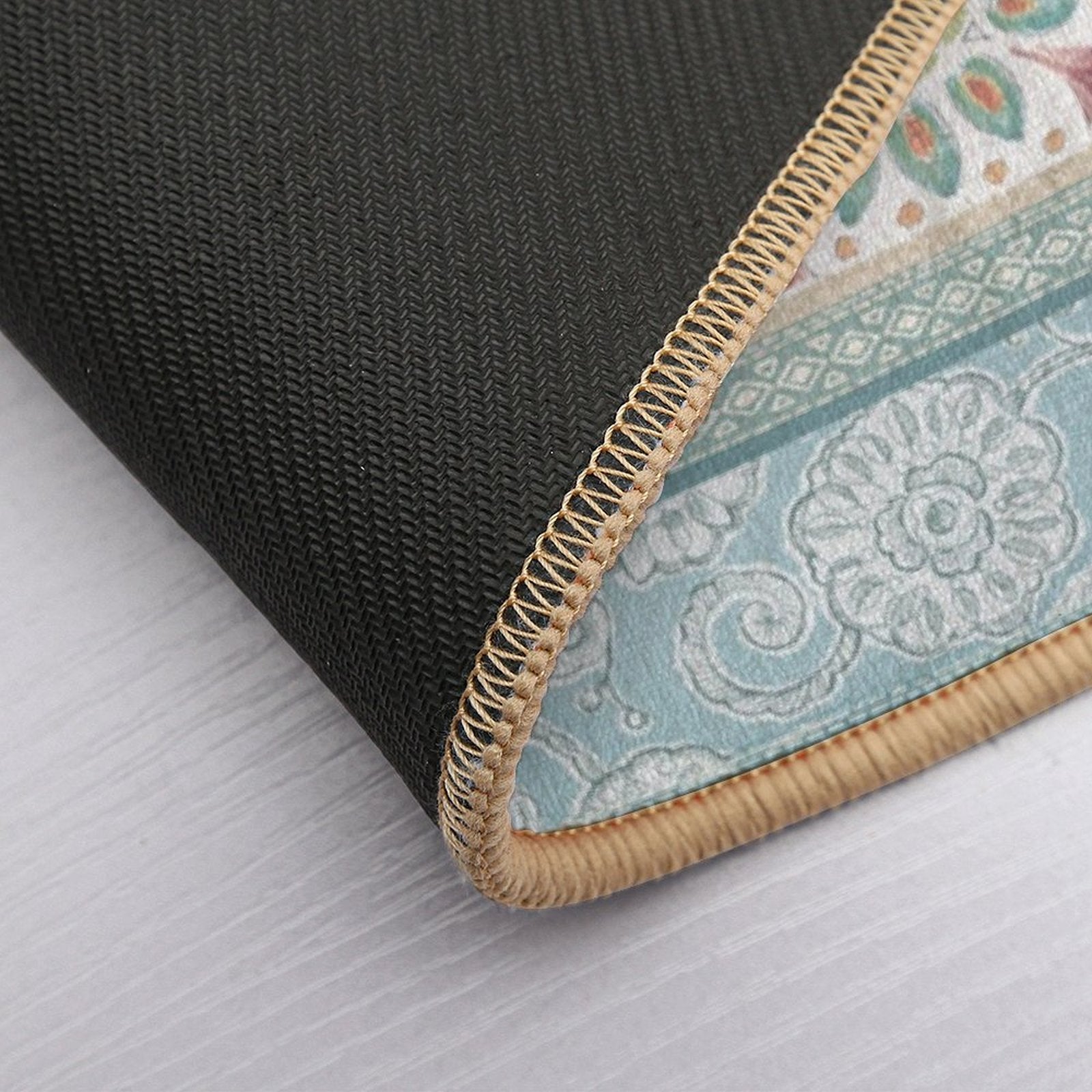 Close-up floor mat detail. Non-slip backing, beige border, floral design in pastel. Perfect for bathroom or bedroom.