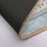 Close-up floor mat detail. Non-slip backing, beige border, floral design in pastel. Perfect for bathroom or bedroom.