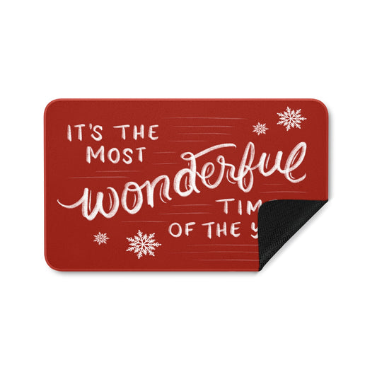 Red rubber entrance doormat with 'It's the Most Wonderful Time of the Year' message, for indoor or outdoor use.