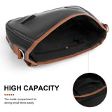 Black PU leather crossbody bag with brown trim, highlighting its high capacity and zippered inner pocket.