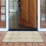 Boho doormat with quatrefoil pattern, cream and gold colors, in front of a wooden door for indoor or outdoor use.