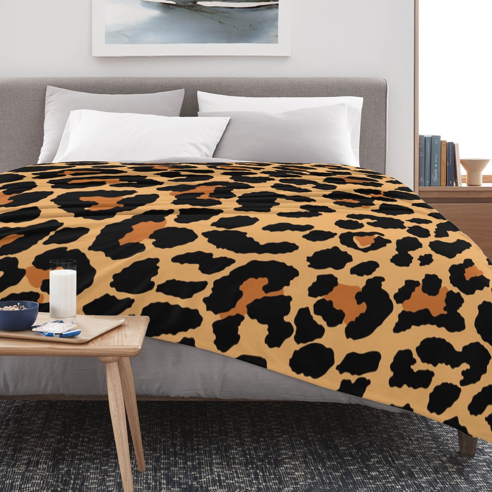 Leopard print flannel blanket on bed, soft and cozy, perfect for home decor.