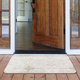 Beige rubber doormat with white wave pattern in front of wooden door.