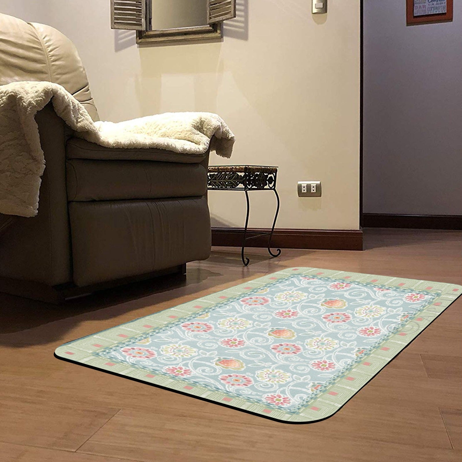 Floral desert door mat, indoor/outdoor use, light blue floral design with green border, on a wooden floor.