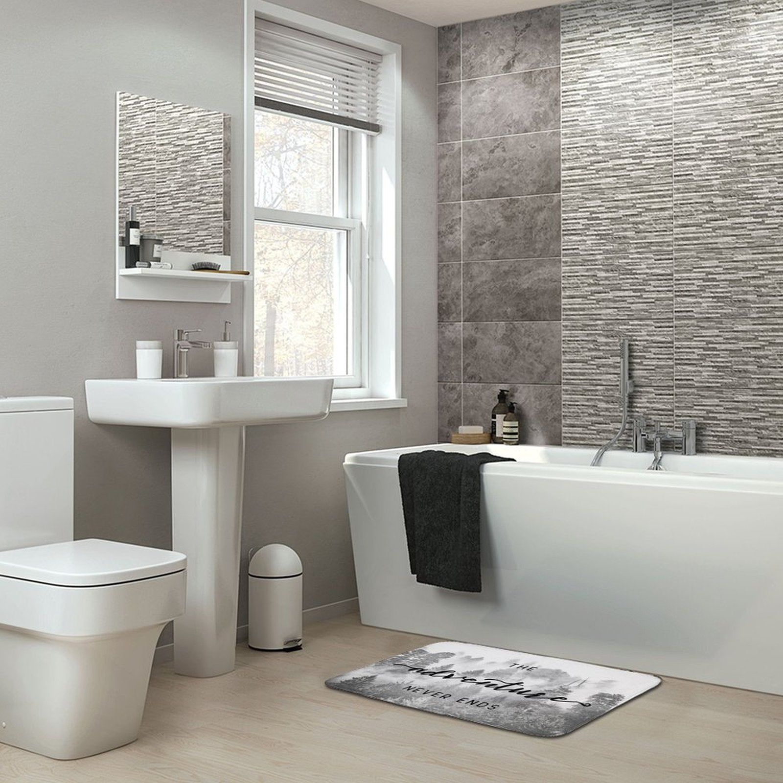 Coral velvet bath rug in bathroom with "The Adventure Never Ends" quote, non-slip and absorbent.