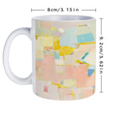 White ceramic mug with colorful abstract art, perfect for gifts and home use, featuring durable design.