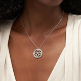 Silver personalized infinite circular necklace pendant with custom engraving 'Your Name' on a woman