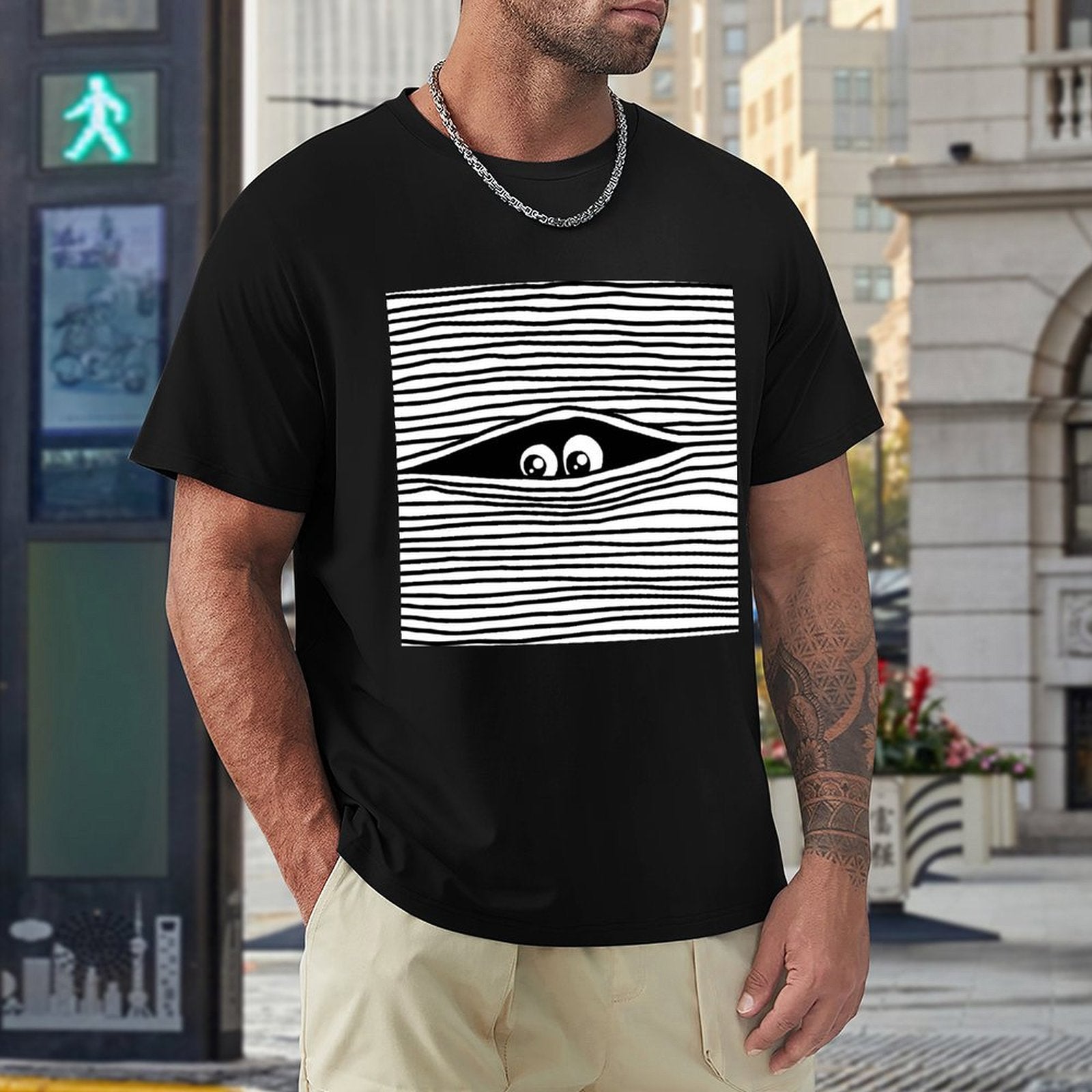 Black crew neck t-shirt with eye graphic for men. Comfortable cotton tee, perfect for everyday wear.
