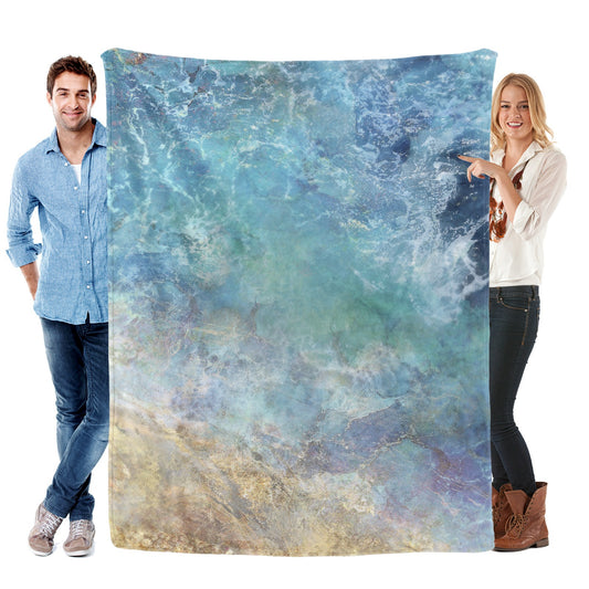 Blue ocean beach flannel blanket held by a couple, ocean wave design, for sofa, couch, or bed