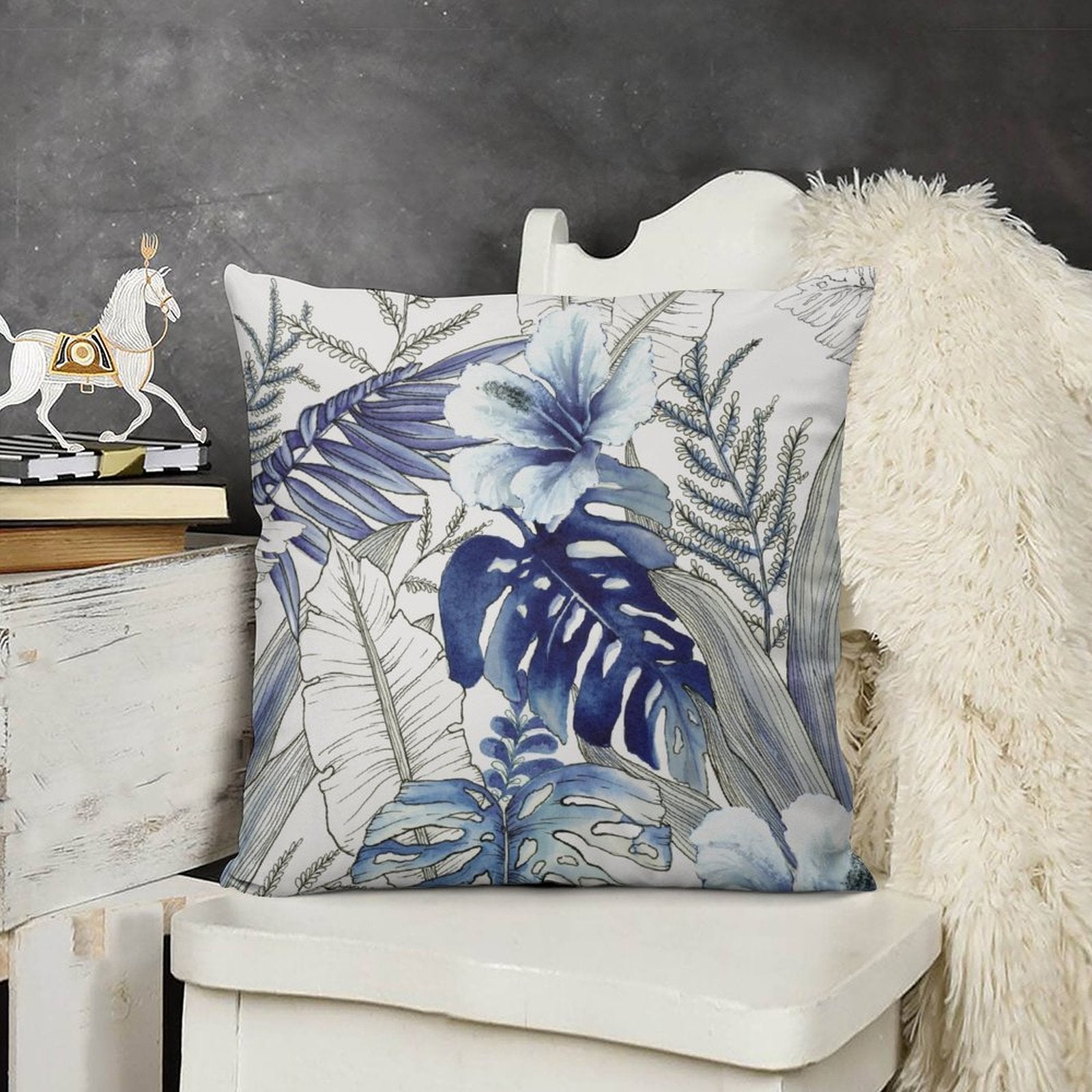 Blue floral pillow cover with tropical design on white chair, soft and fluffy, perfect for sofa or living room