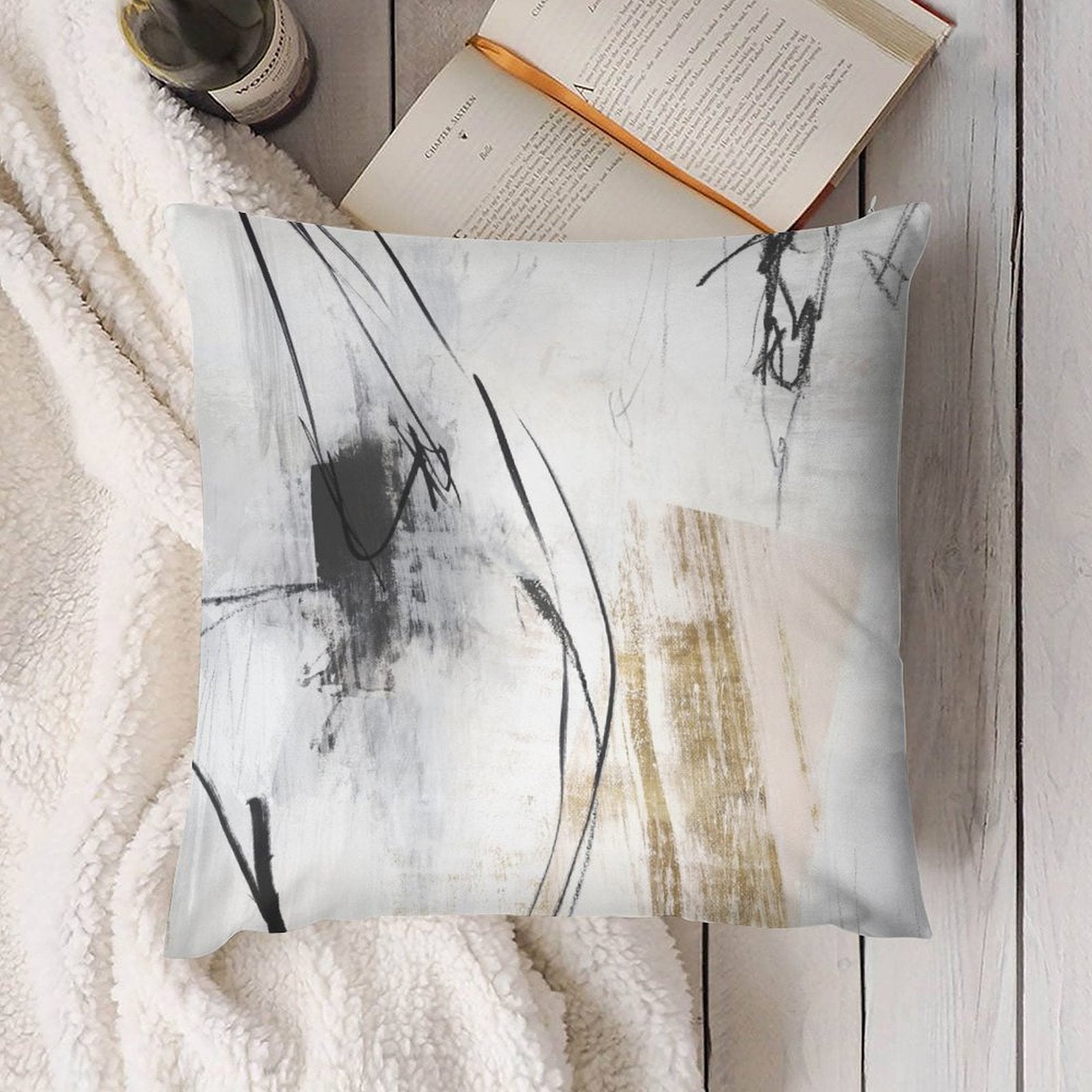 Square throw pillow with abstract art. Short plush cover for home decor, featuring black, white, and gold.