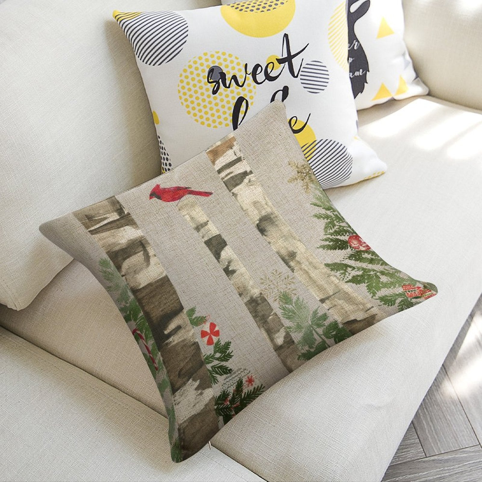 Christmas linen pillow cover with birch tree, cardinal design, and 'sweet love' accent pillow on sofa