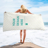 Customizable beach towel, personalized with heart pattern, featuring 'YOUR DESIGN HERE' on the beach.