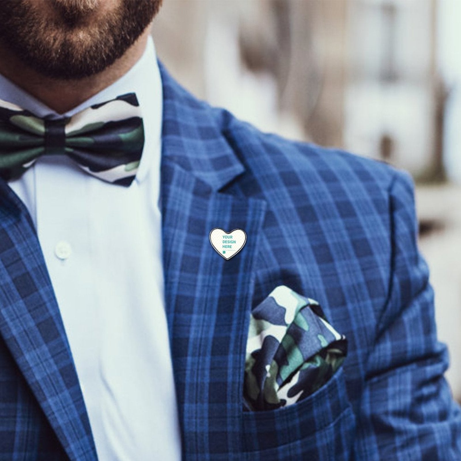 Customizable heart-shaped lapel pin on blue plaid jacket. Features 'YOUR DESIGN HERE' design, personalized gift.