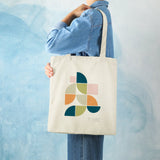 Canvas tote bag with Mid Century Geo II design, Wild Apple logo, perfect for shopping. Made of cotton blend material.