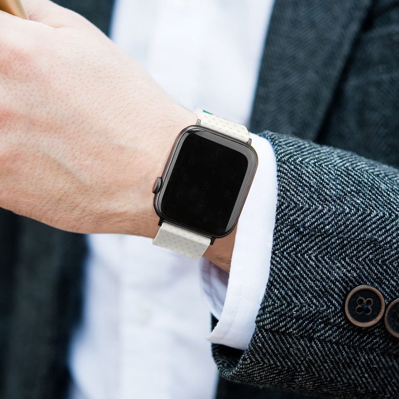 White silicone Apple Watch band with yellow dot pattern on wrist, custom Iwatch strap.