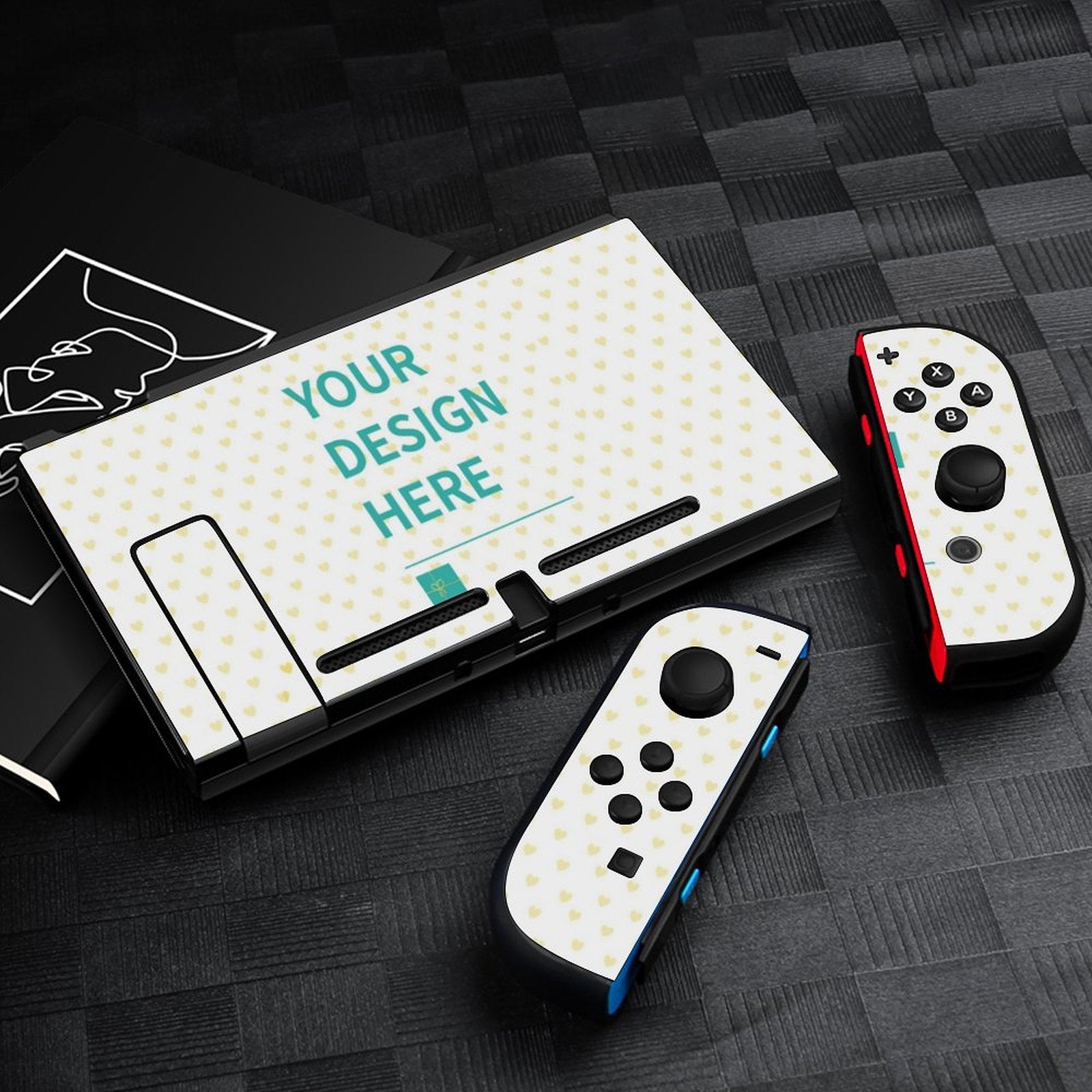 Custom Nintendo Switch skin with 'YOUR DESIGN HERE' text, featuring heart pattern and full coverage protection