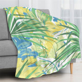 Green tropical plants flannel blanket draped over a gray sofa, featuring a vibrant floral design.