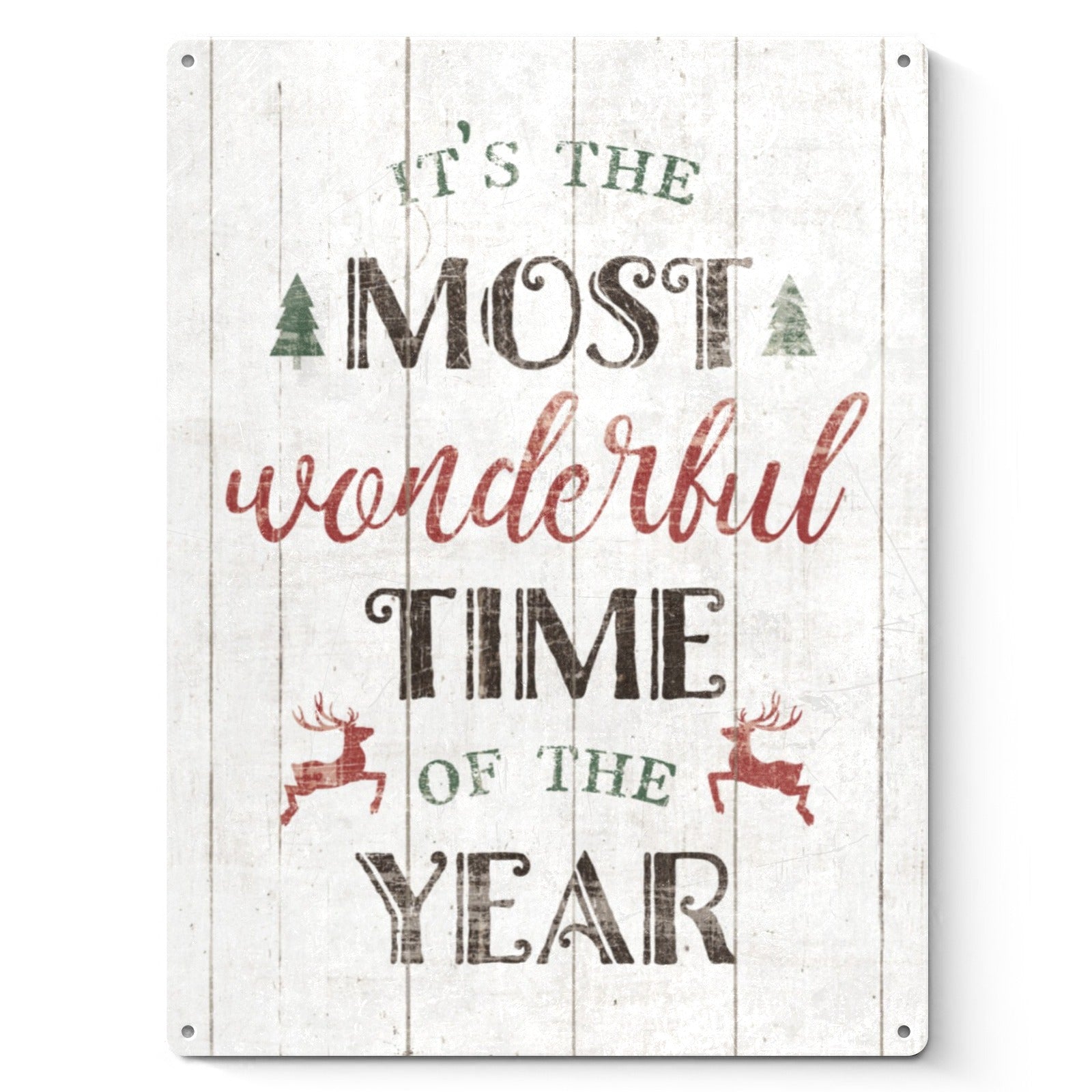Christmas metal sign with distressed look, "It's the Most Wonderful Time of the Year" on white wooden background, home decor.