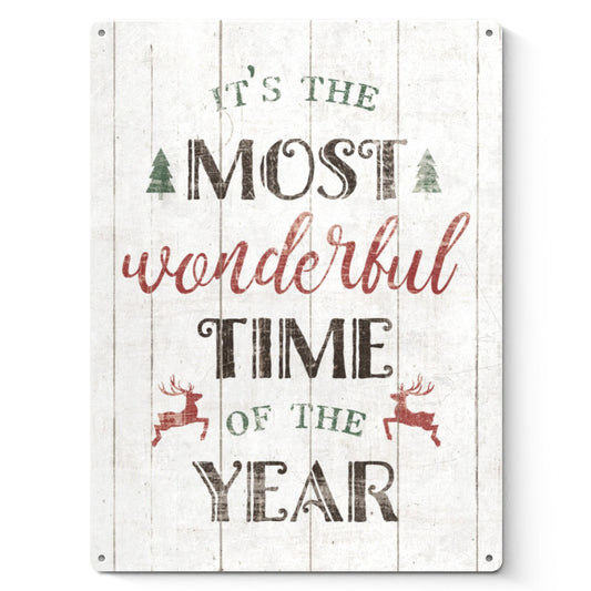 Christmas metal sign with distressed look, "It's the Most Wonderful Time of the Year" on white wooden background, home decor.