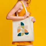 Canvas tote bag with Mid Century Geo II design, made of cotton, ideal for shopping. Features Wild Apple logo.