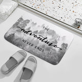 Coral velvet bath rug with misty forest design and "The Adventure Never Ends" quote for bathroom; non-slip.