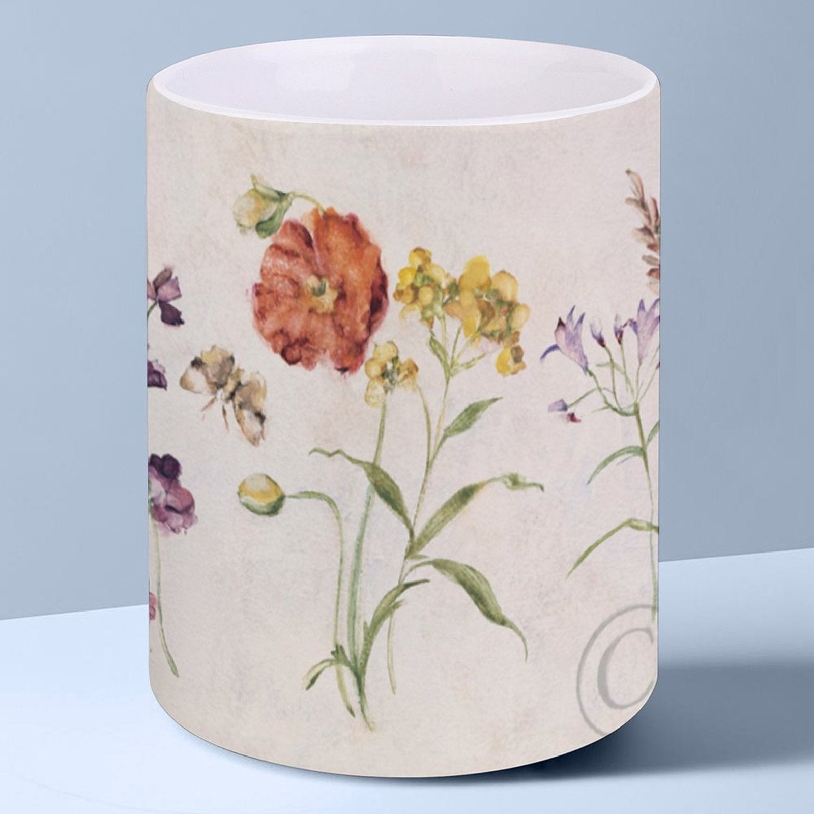 White ceramic mug with wildflower design. Perfect for home or office. Customizable gift.