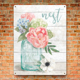 Metal sign with pastel flowers in a jar and 'nest grow' text, floral wall art