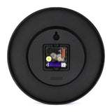 Black round wall clock back showing quartz movement and battery slot for a quiet home decor clock, "QUARTZ" detail.