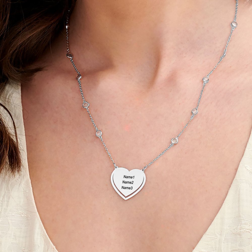Personalized silver heart pendant necklace with custom engraved names, perfect gift.