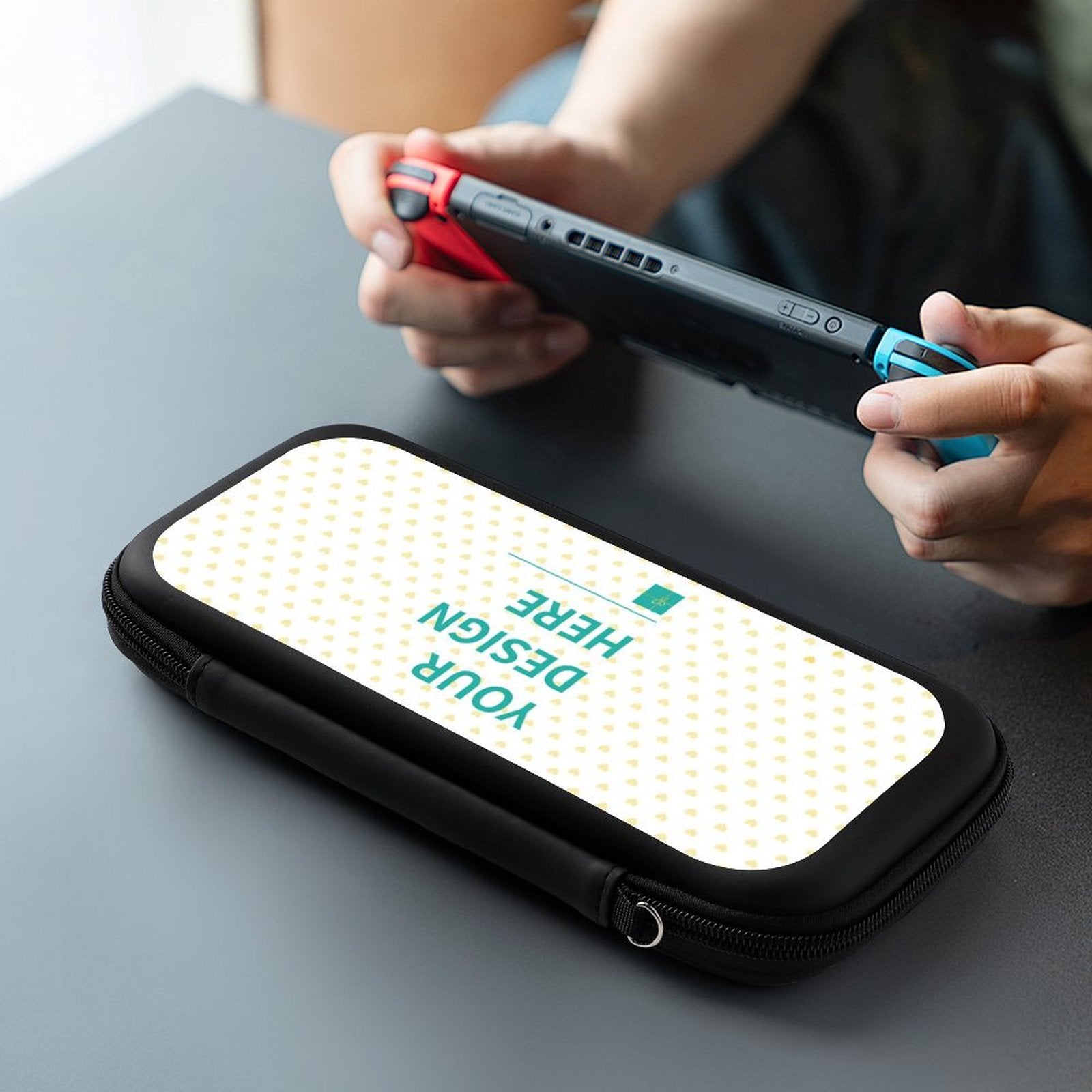 Custom black Nintendo Switch carrying case with 'YOUR DESIGN HERE' text, suitable for travel.