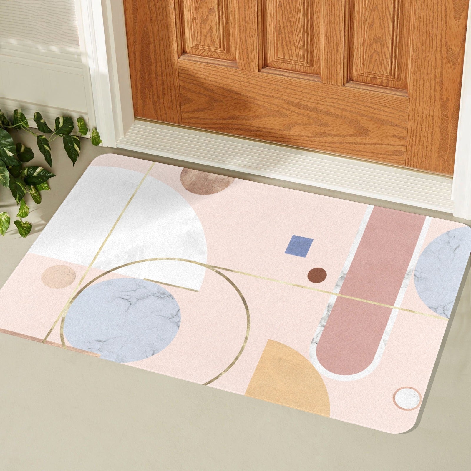 Pink abstract entrance doormat with geometric design and rubber backing for indoor or outdoor use