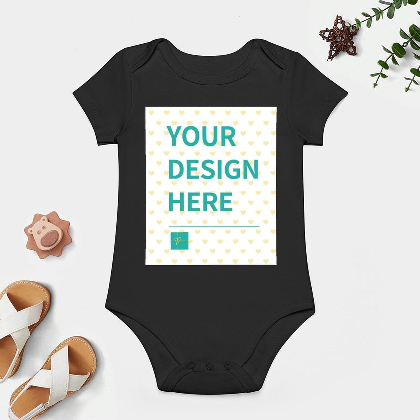 Customizable black baby bodysuit with 'YOUR DESIGN HERE', soft cotton, perfect for boys and girls. Personalized baby gift.