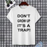 White Gildan unisex t-shirt with "DON'T GROW UP IT'S A TRAP!" print, perfect for casual wear.