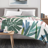 Tropical Plants Flannel Blanket on bed with watercolor design, green leaves, USA made home decor