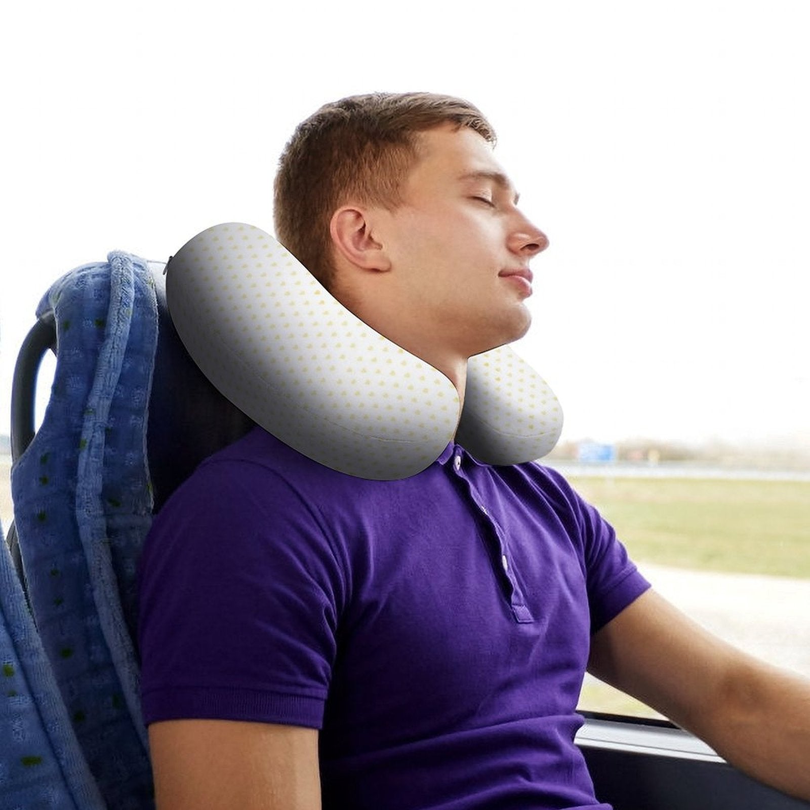 Man on bus wearing U-shaped travel pillow, memory foam for neck support and comfort, perfect for travel.