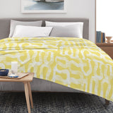 Cross Yellow Flannel Blanket on bed, Made in USA, with yellow and white abstract design, home decor