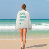 Custom beach towel, double-faced pile, personalized with 'YOUR DESIGN HERE', on a woman at the beach