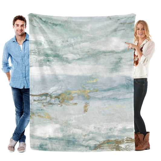 Green abstract flannel blanket for sofa with watercolor design held by models, made in USA