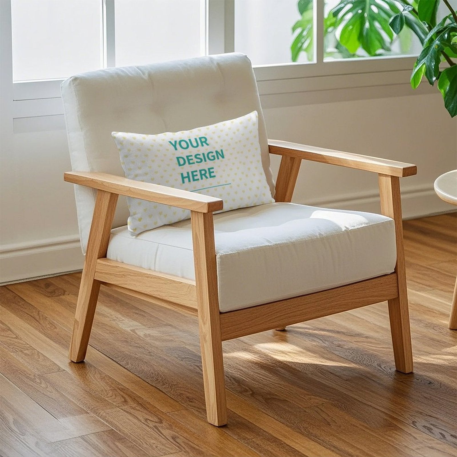 Customizable throw pillow on a wooden chair, featuring "YOUR DESIGN HERE", perfect for living room decor