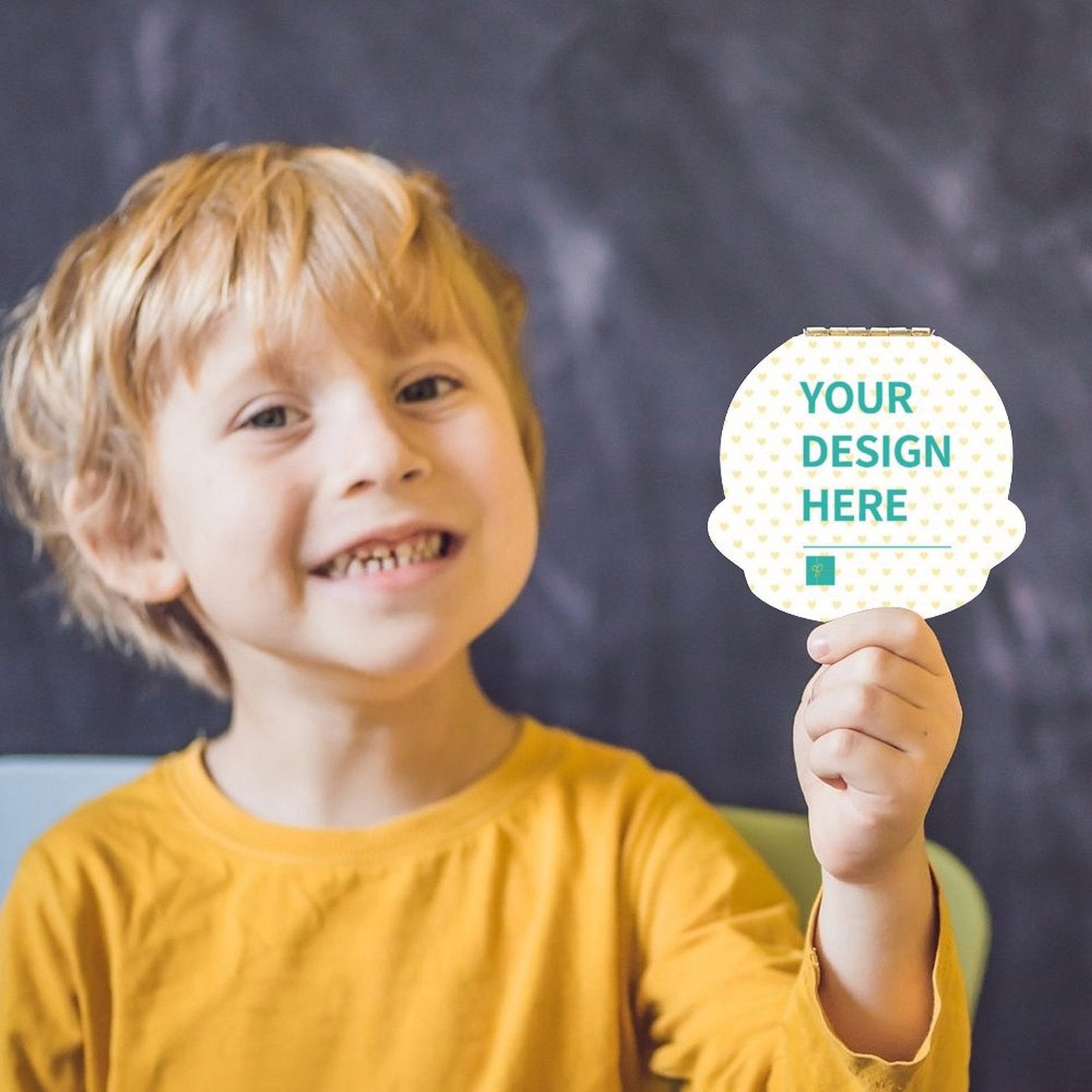 Smiling boy with personalized tooth box featuring 'YOUR DESIGN HERE', a keepsake gift