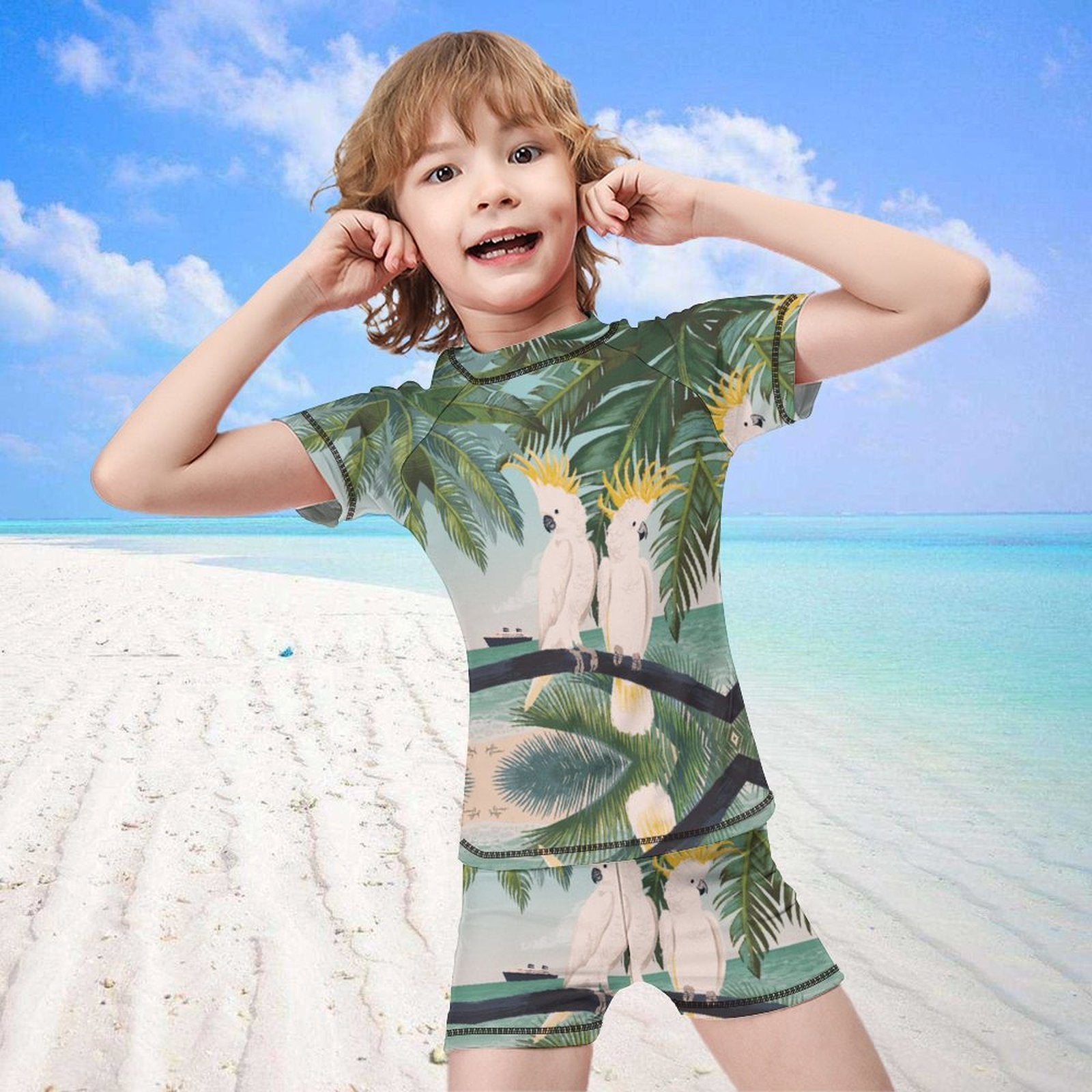 Boys' rash guard set with parrot design, short sleeve shirt and swim trunks, perfect for summer swimming.