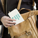 Customizable passport holder with 'YOUR DESIGN HERE' text inside a bag, PU leather travel gift