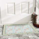 Floral door mat with blue floral design and a green border, perfect for indoor/outdoor use.