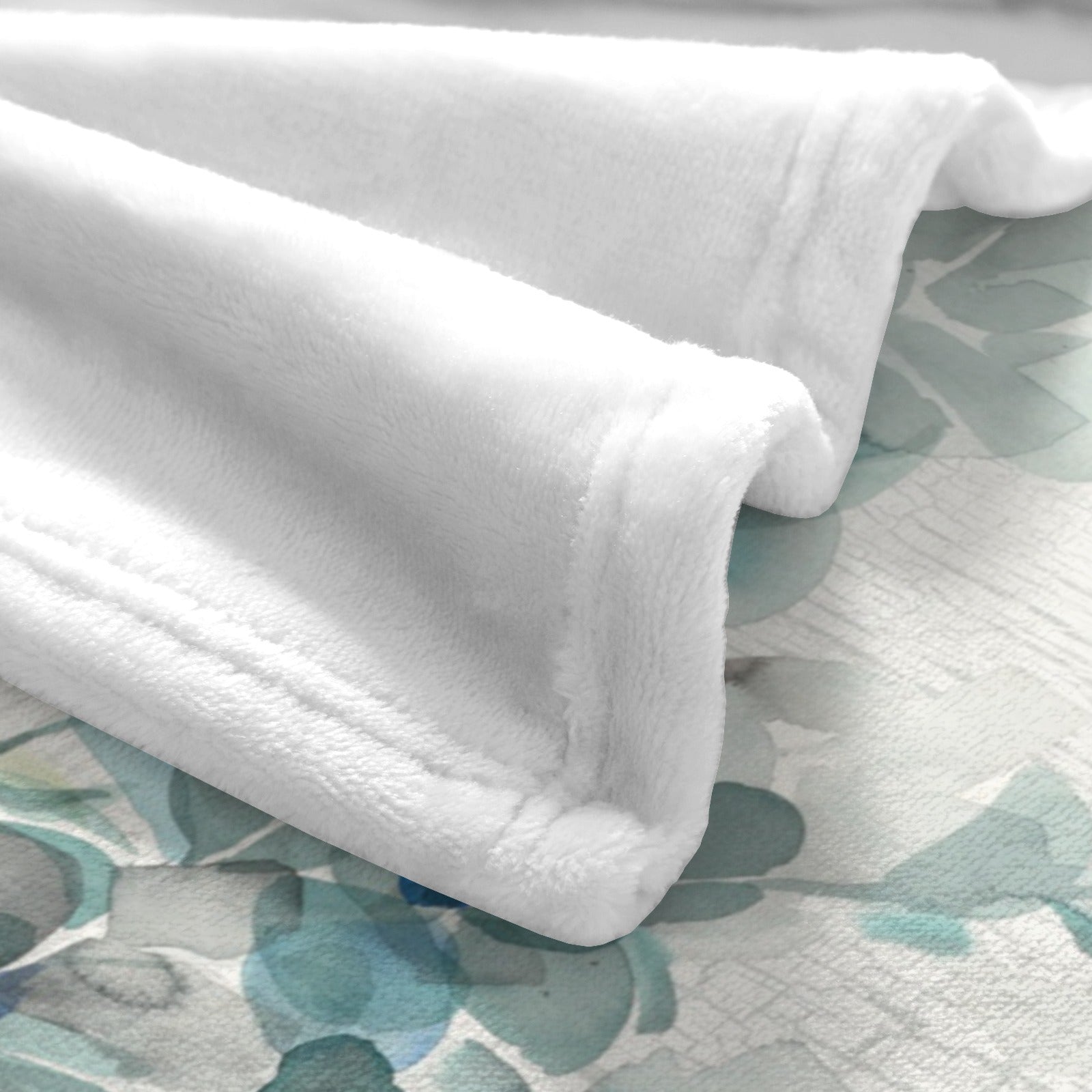 White polyester flannel blanket with watercolor eucalyptus design, perfect for cozy home decor.