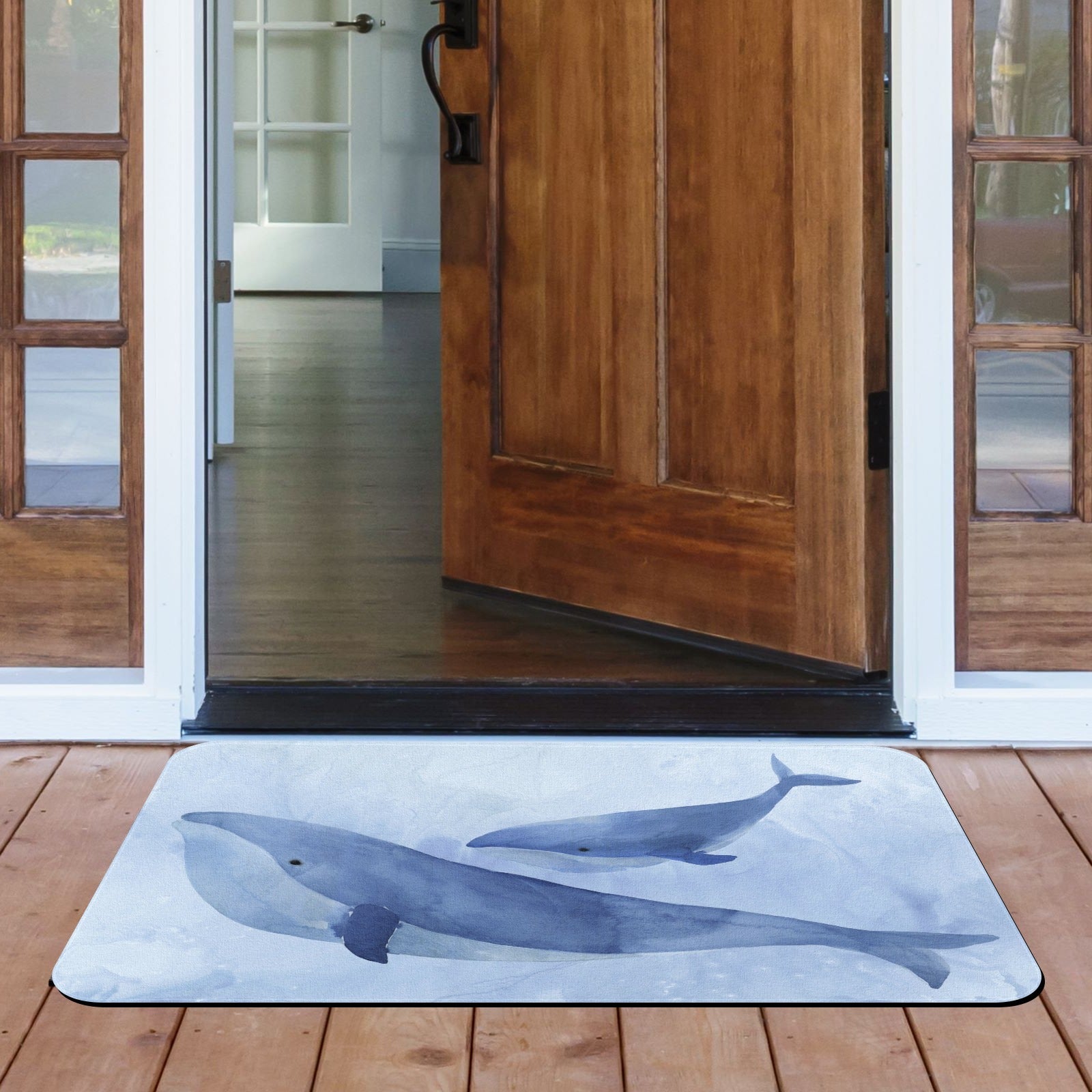 Blue Whale II doormat on wooden porch, watercolor whale design, indoor/outdoor rubber mat