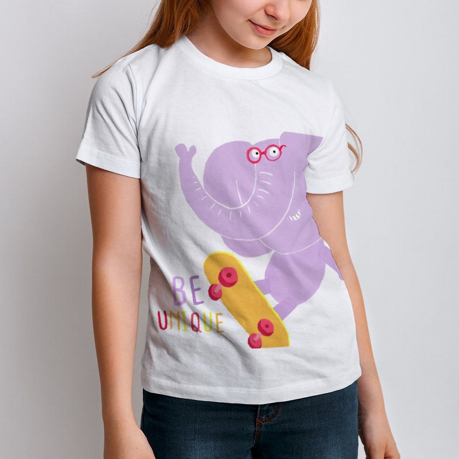 Kids' white short sleeve t-shirt with skateboarding purple elephant graphic, 'BE UNIQUE' text, and a yellow skateboard