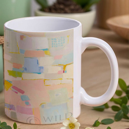 White ceramic mug with colorful abstract design, suitable for home or office use. Durable and elegant gift.