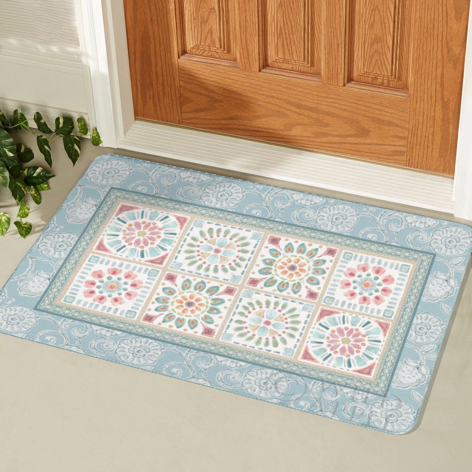 Blue floral door mat with a desert design, ideal for indoor or outdoor use, placed in front of a wooden door.